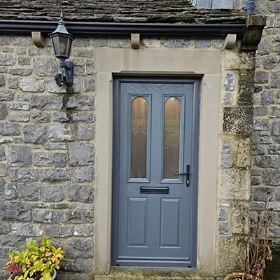 A blue front door of a stone building.